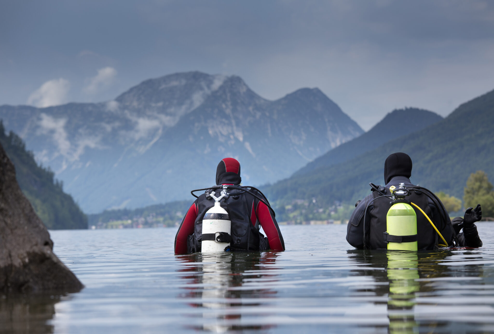 Two divers getting ready to descend in a mountain lake.