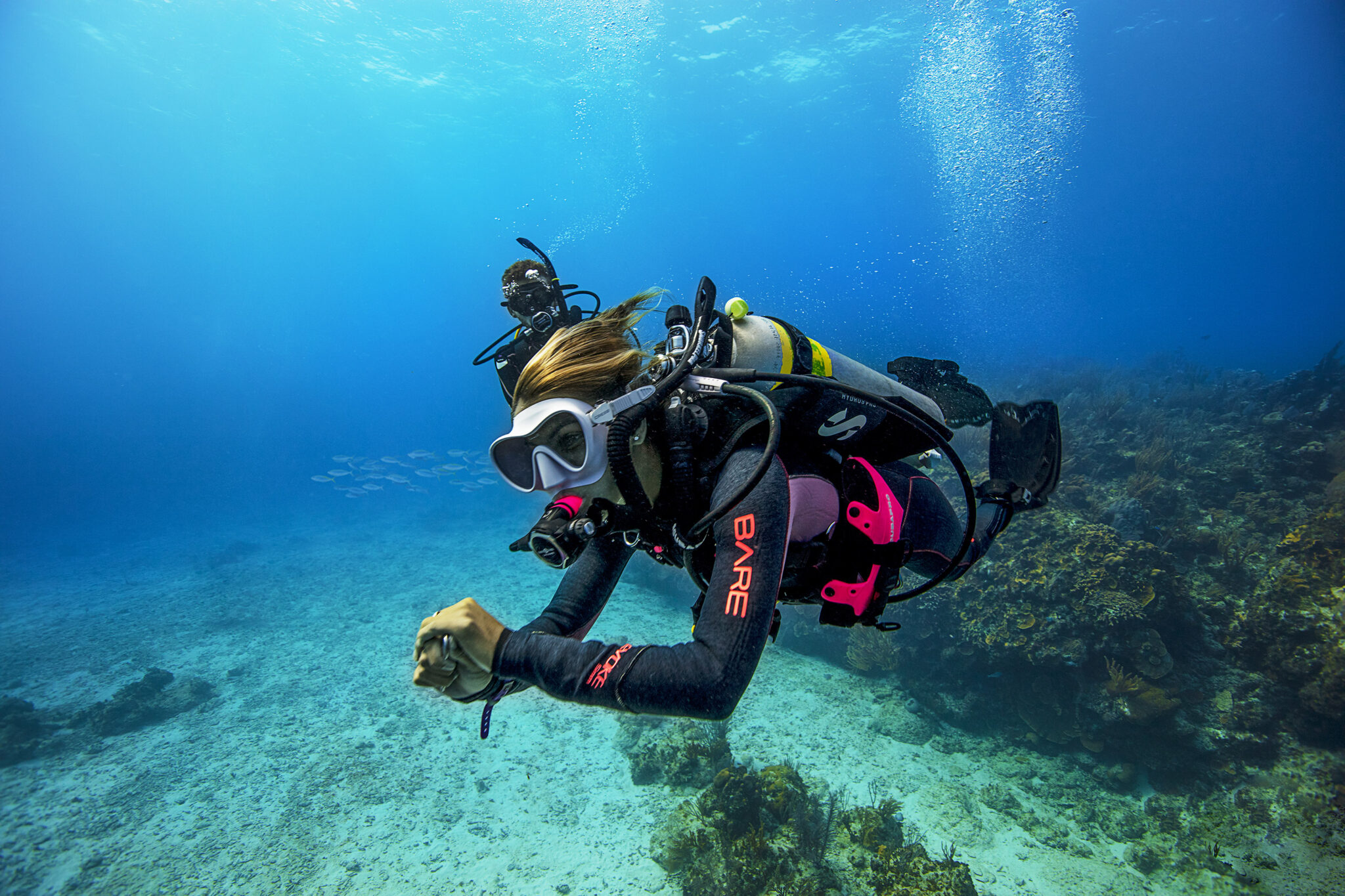 A PADI Enriched Air Diver swimming underwater who is enjoying extended bottom time, one of many advantages of nitrox diving