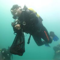 scuba diver collecting trash