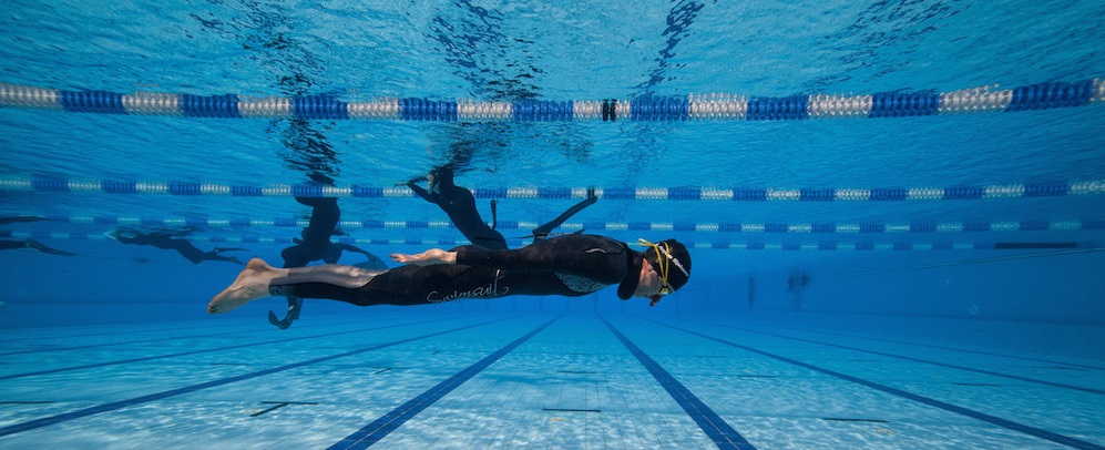 Freediver practicing Dynamic apnea in a pool.

