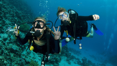 two divers looking at the camera underwater