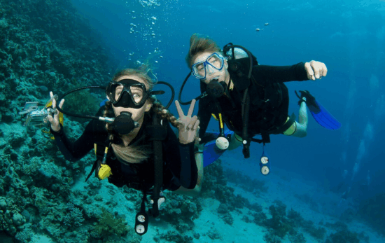 two divers looking at the camera underwater