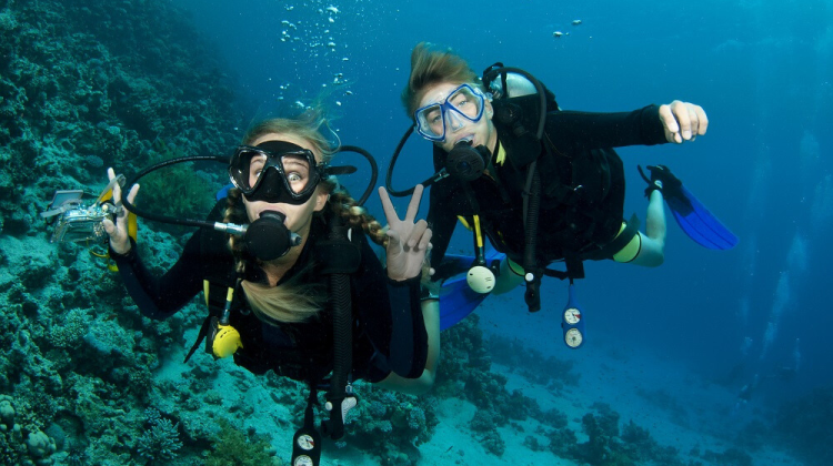 two divers looking at the camera underwater