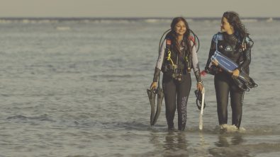 two female divers exit the ocean in Egypt