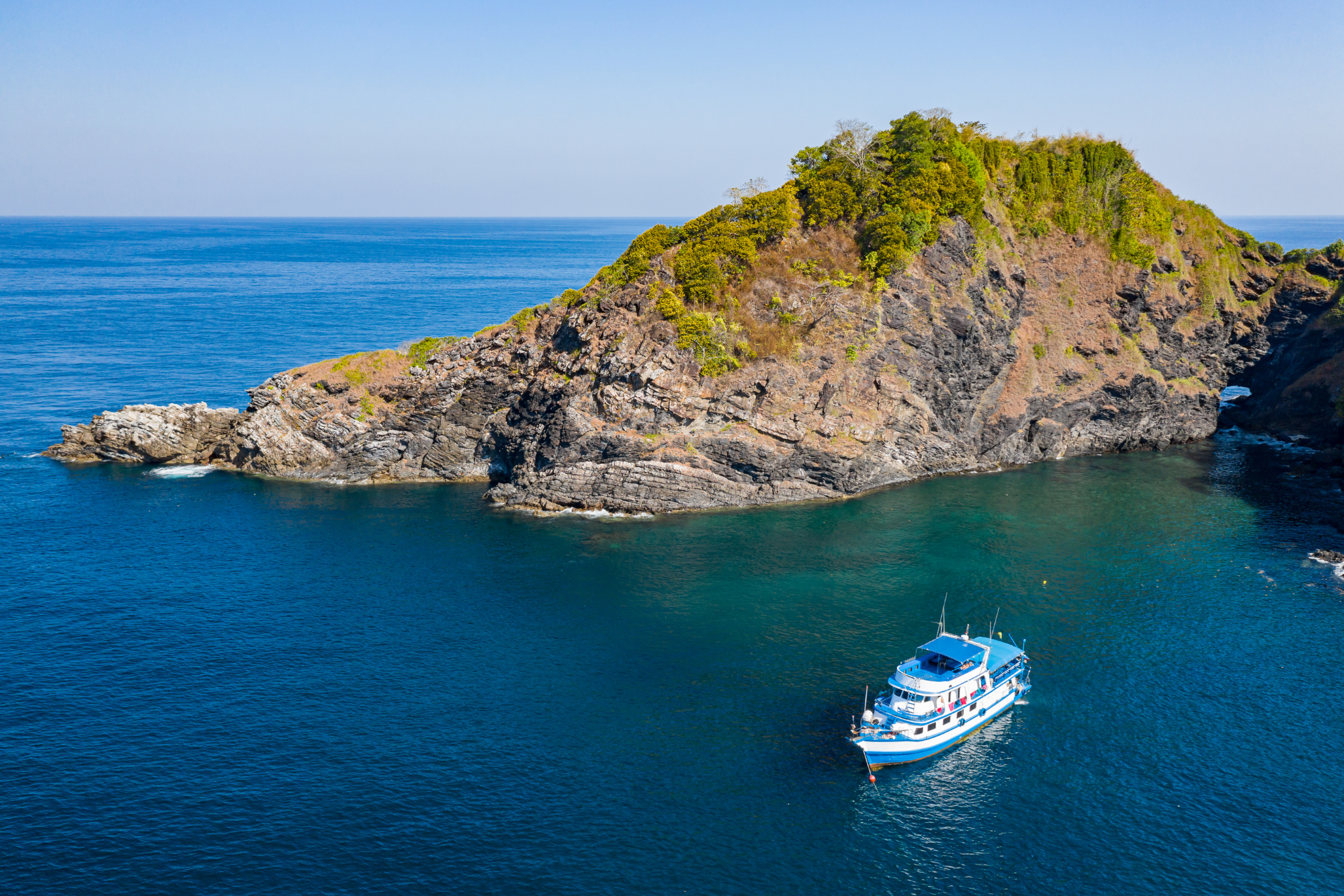 Liveaboard on the water, anchored near an island