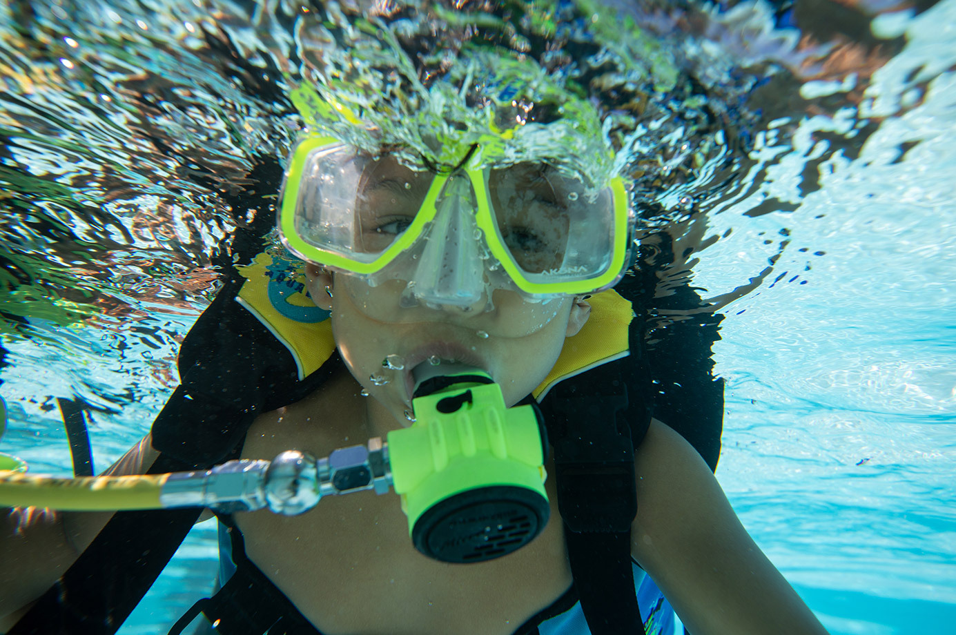 An 8-year-old diver takes his first breaths underwater