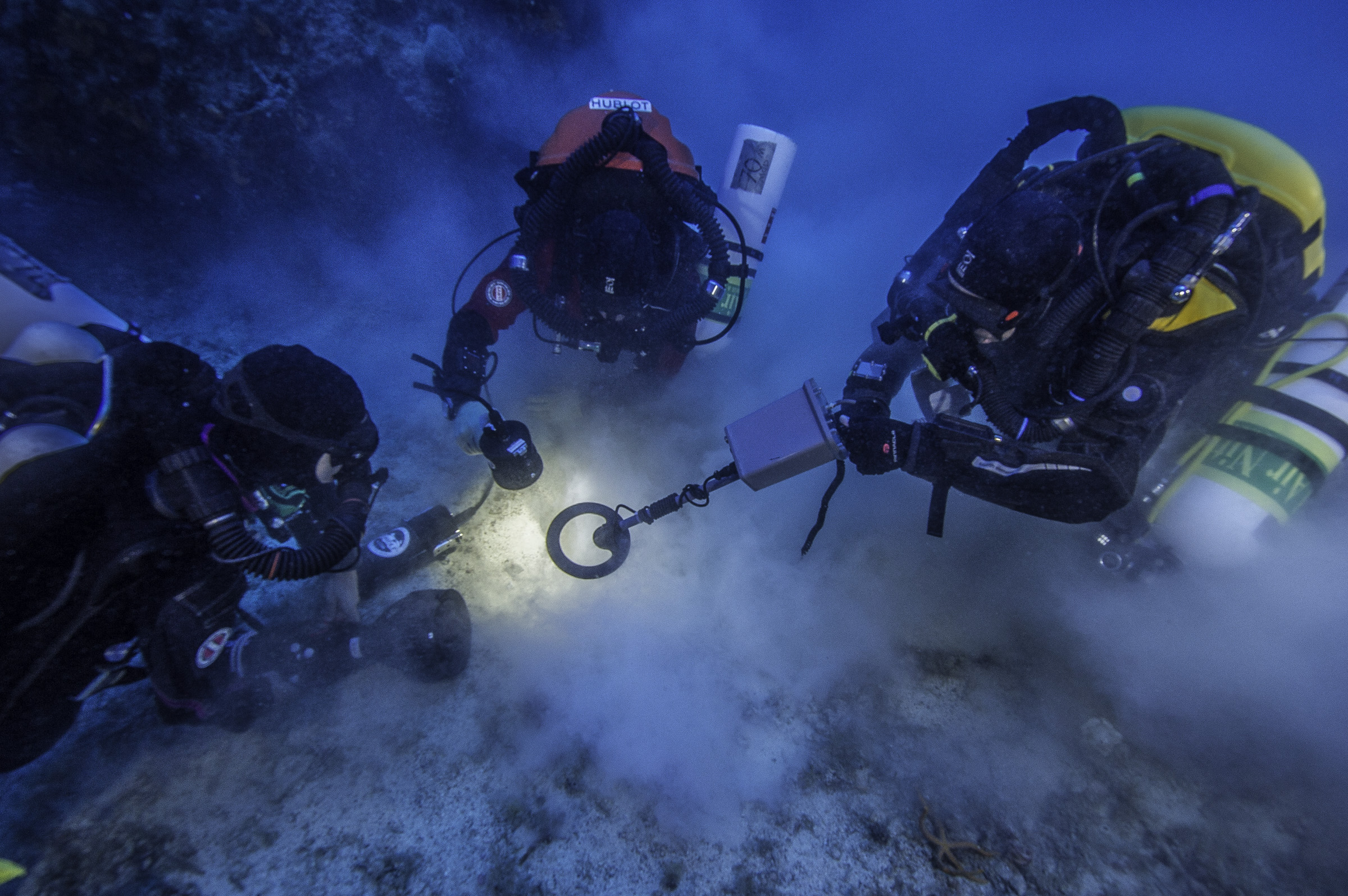 underwater archeologists analyze a dive site - underwater archeology is a scuba diving job that is challenging and rewarding