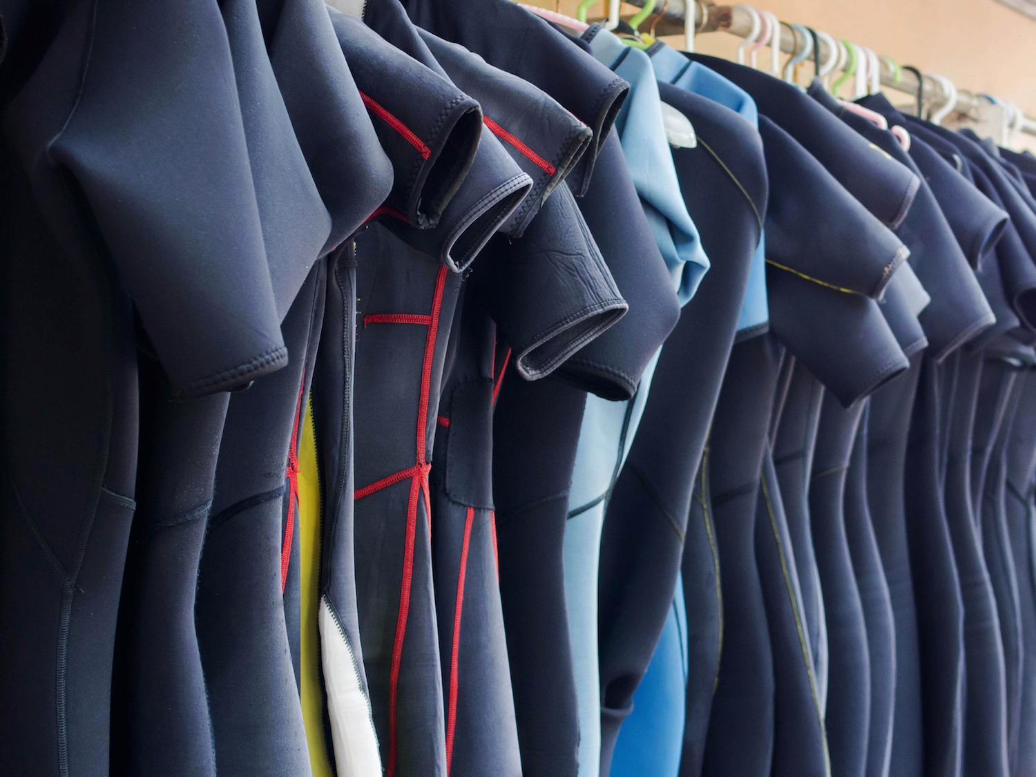 Wetsuits on a rail, which don't need as much maintenance as drysuits, which is a difference between a wetsuit and a drysuit