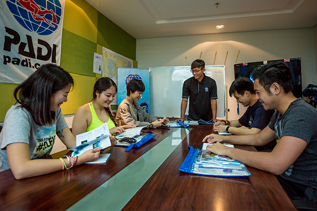 Students learn dive theory in a classroom open water referral