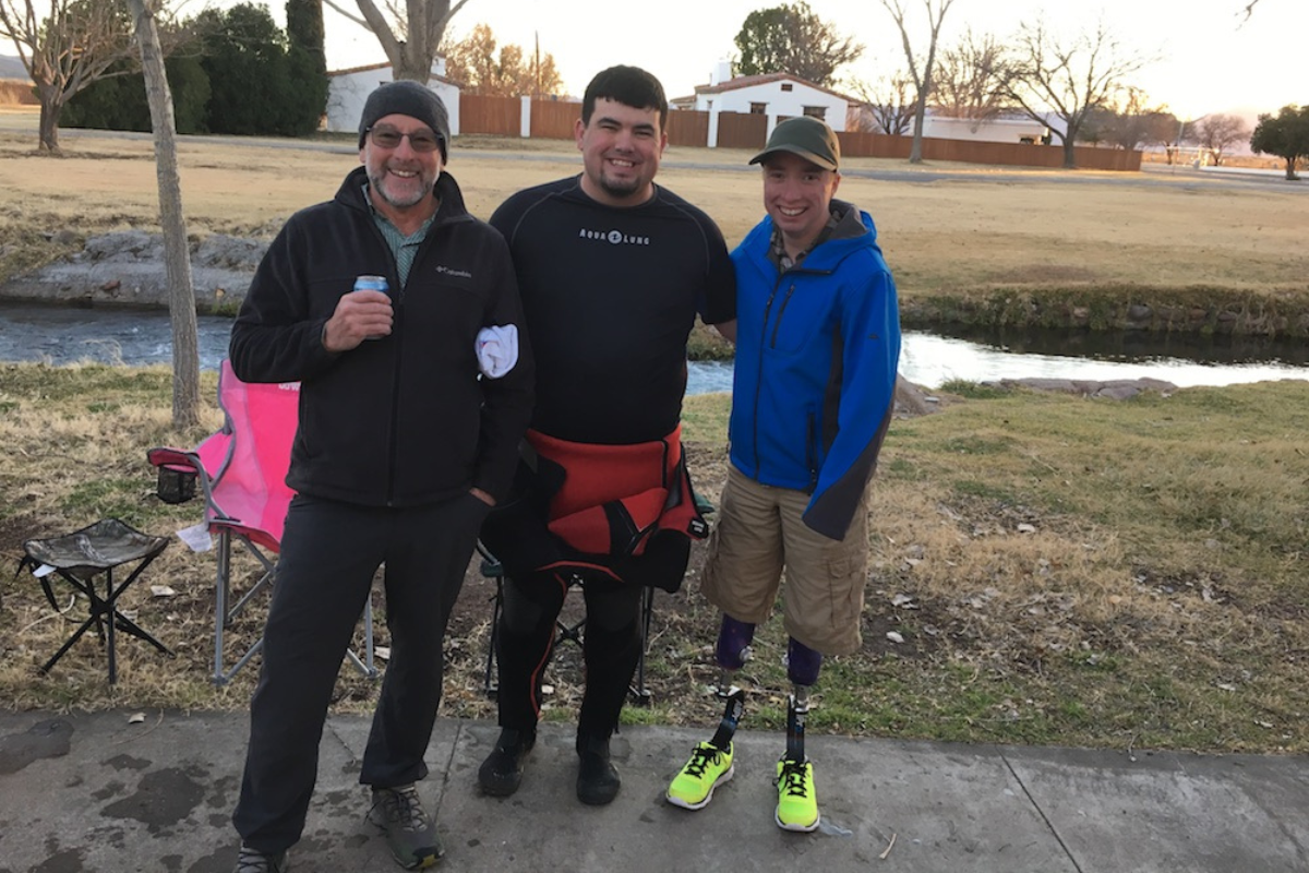 Riley standing with those who helped him become a PADI Master Scuba Diver.