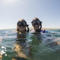 happy divers smiling at the surface