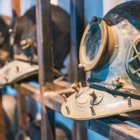 old diving helmets in a row