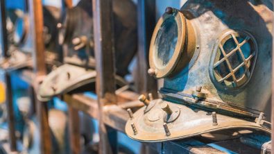 old diving helmets in a row