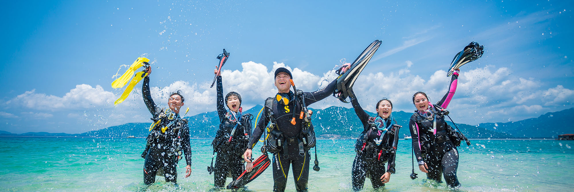 happy divers celebrating in the water