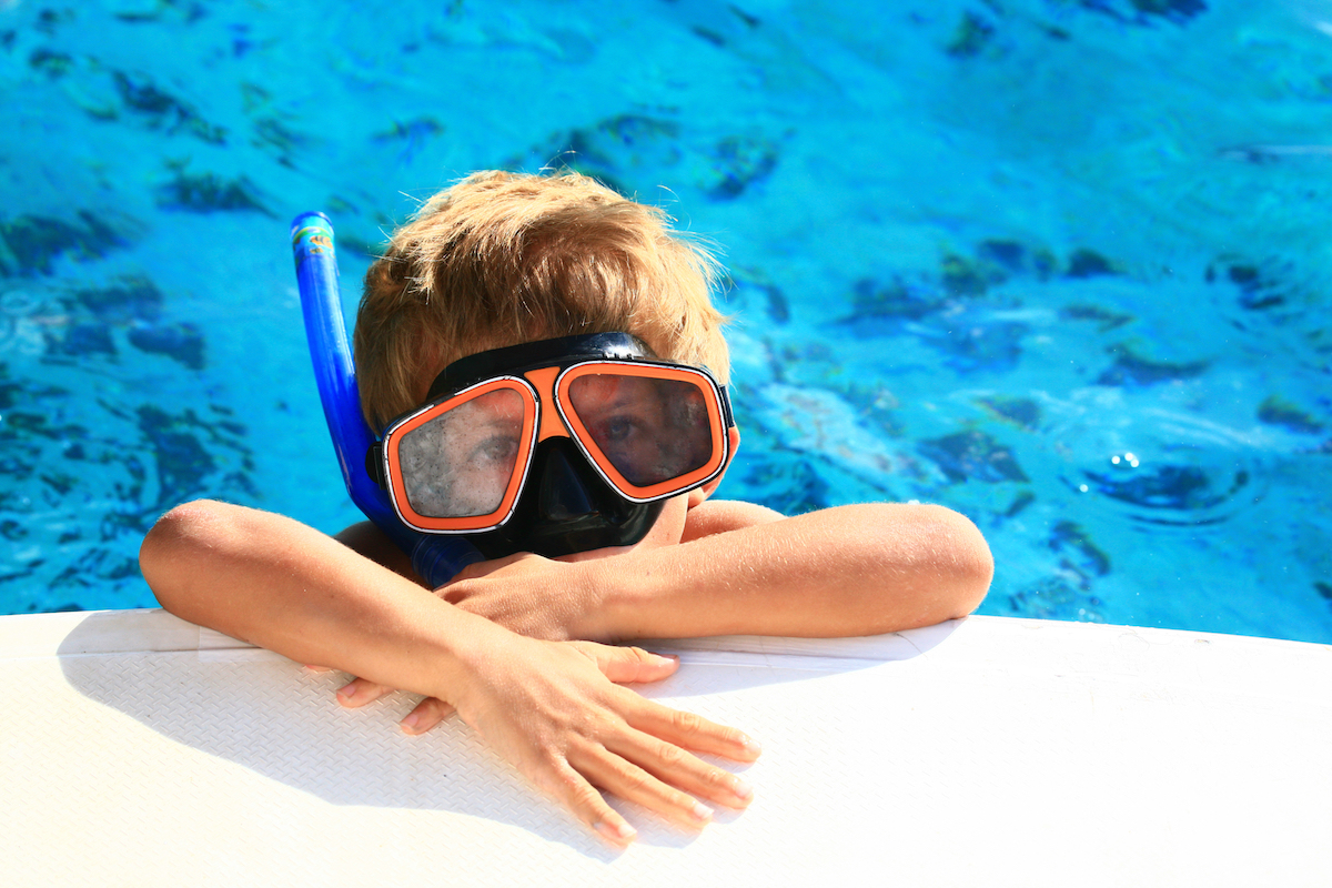 Kid snorkeling off boat