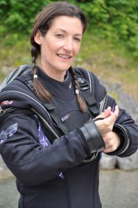 A female diver wearing a Fusion dry suit