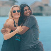 two female divers hug each other in the Maldives