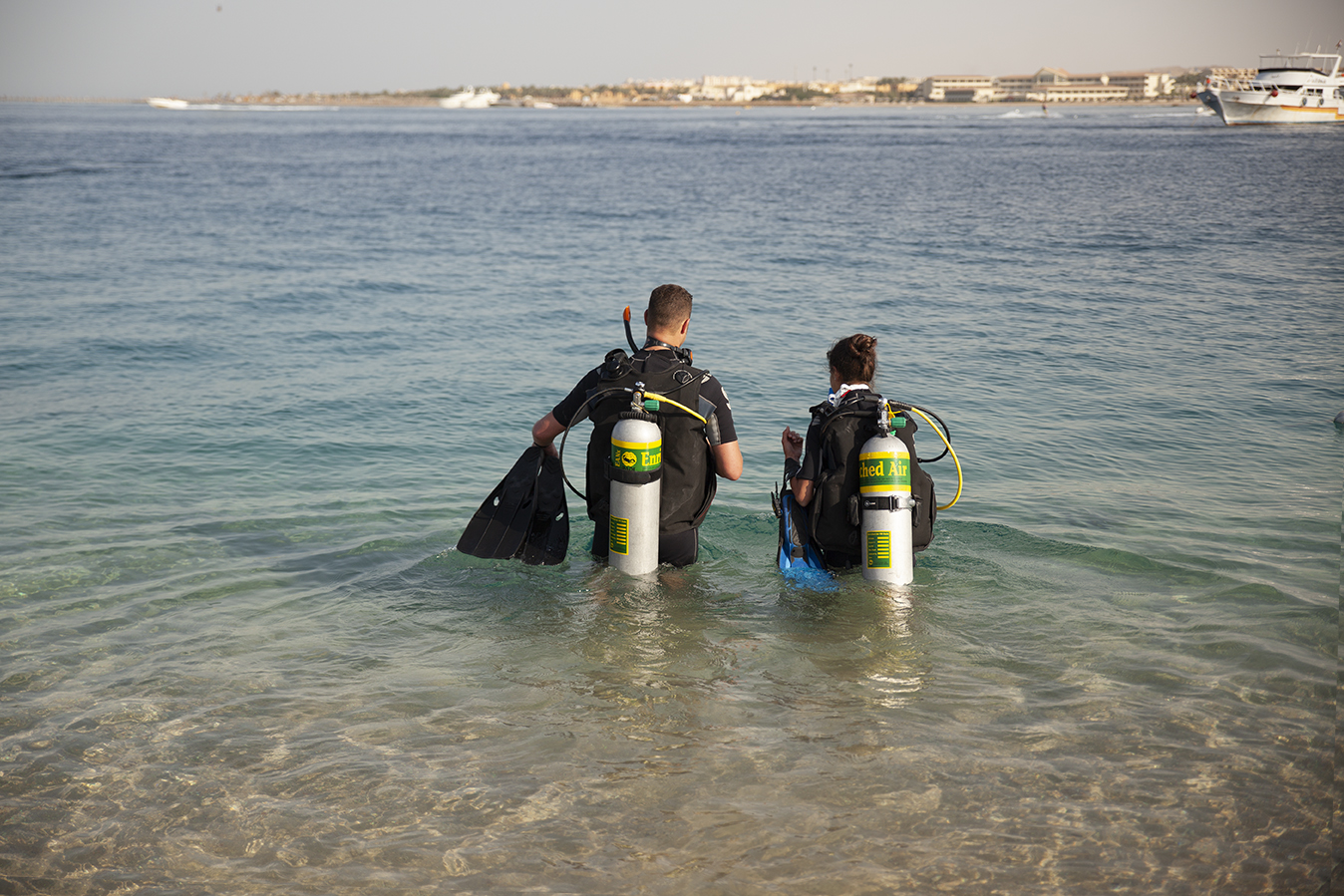 Two divers enjoying a scuba vacation and making use of the advantages of nitrox when doing multiple dives over several days