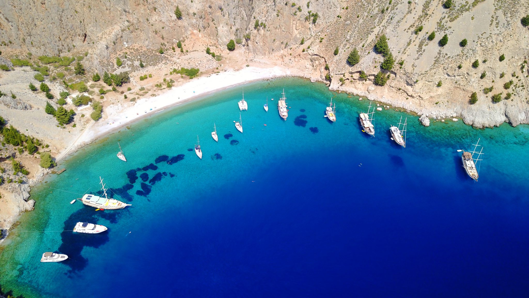 aerial photo boats parked around a clear water bay