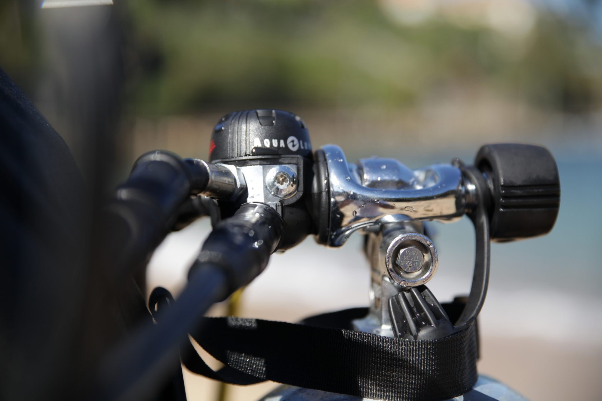 A scuba regulator first stage, which connects second stages to the cylinder and is part of every scuba gear beginner set