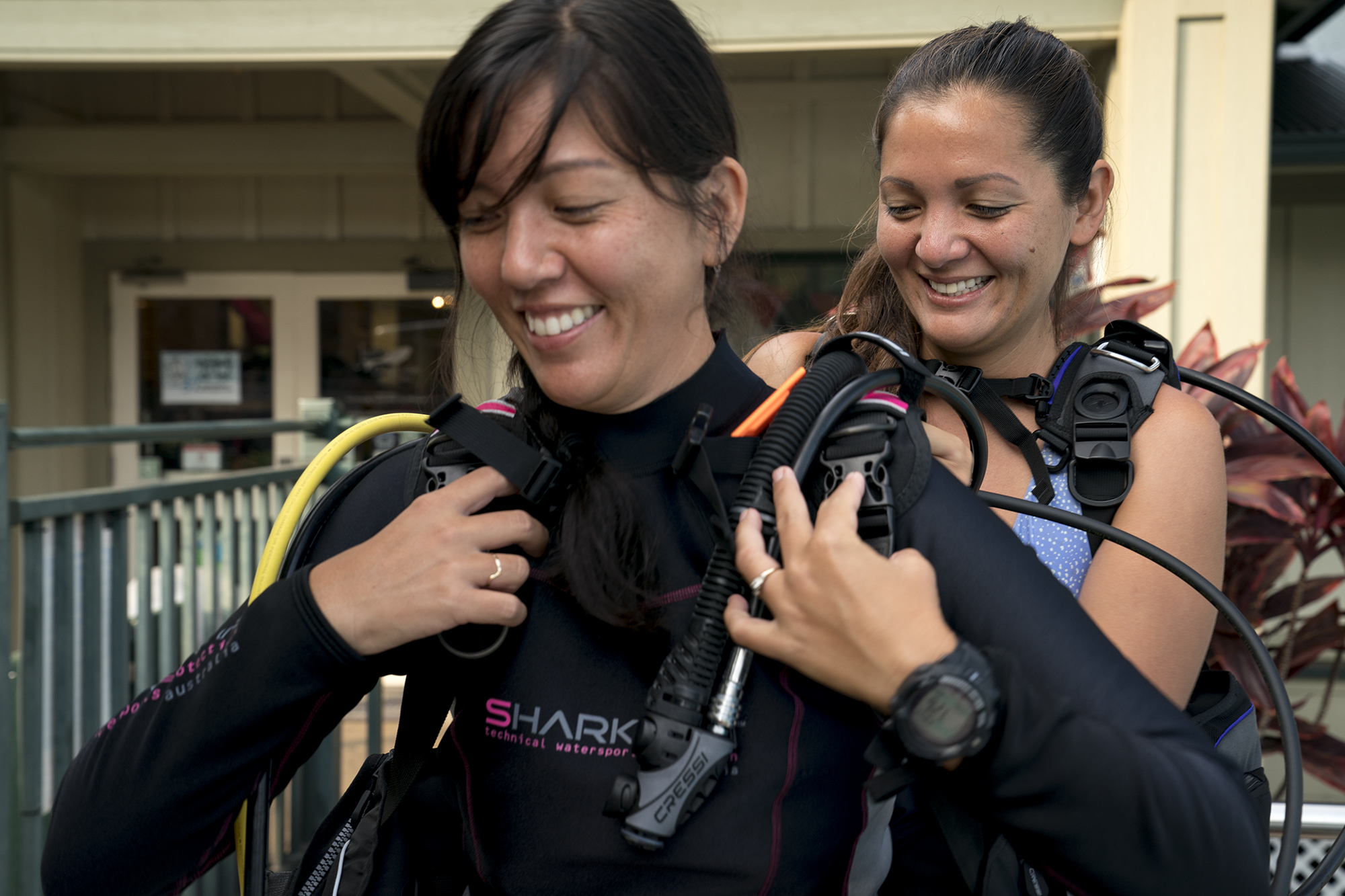 Two scuba divers preparing their gear before the course