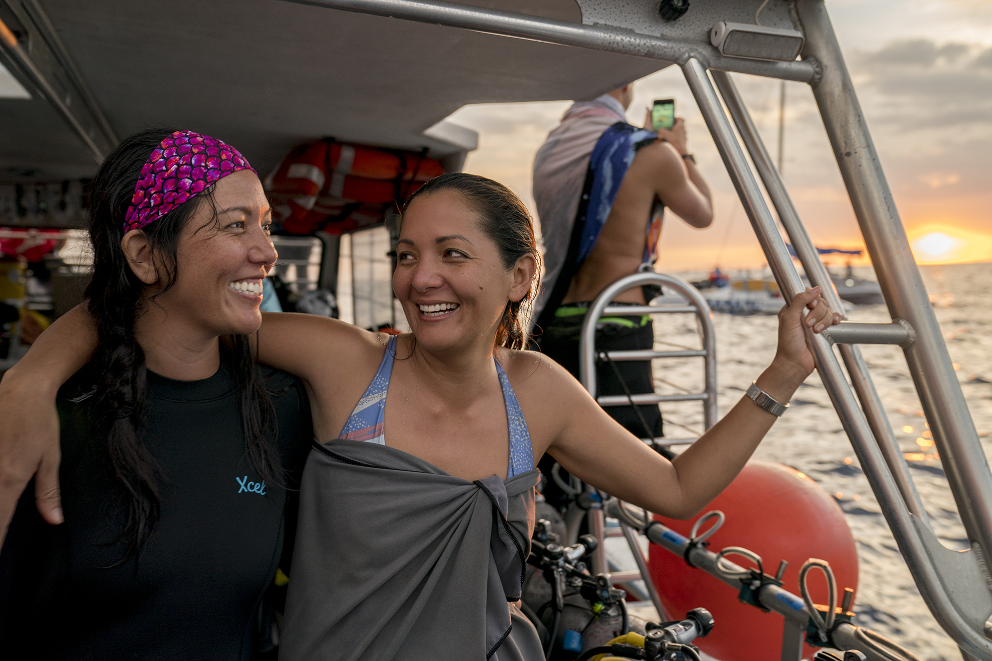 two sisters on a dive boat in hawaii