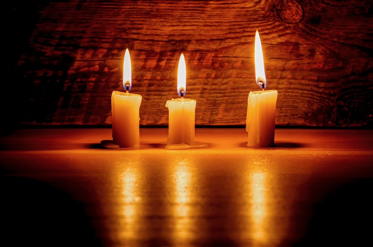 Background with candles light on wood in dark