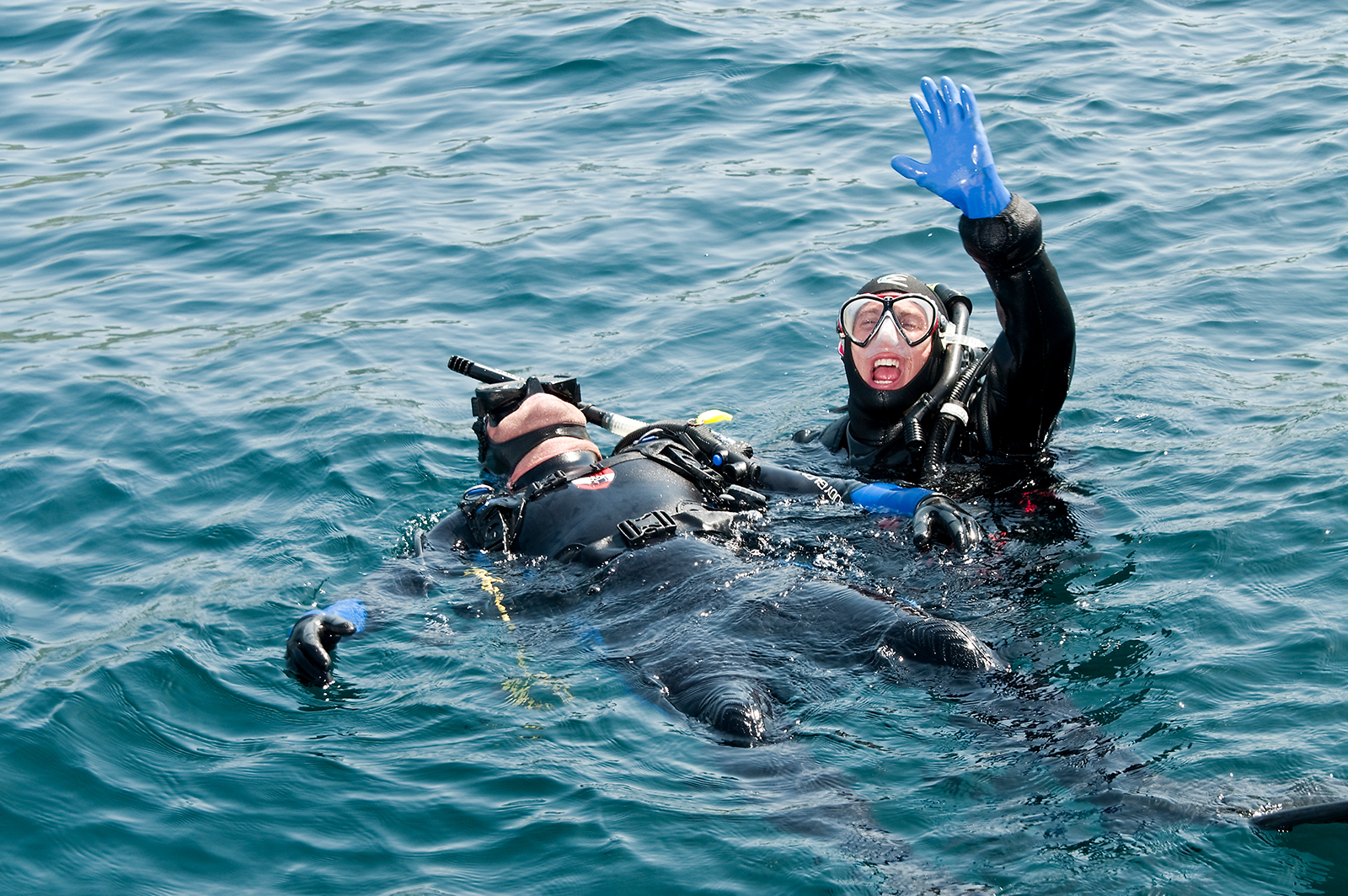 Two divers in the water practicing emergency skills as part of the PADI Rescue Diver course, one of the best PADI courses