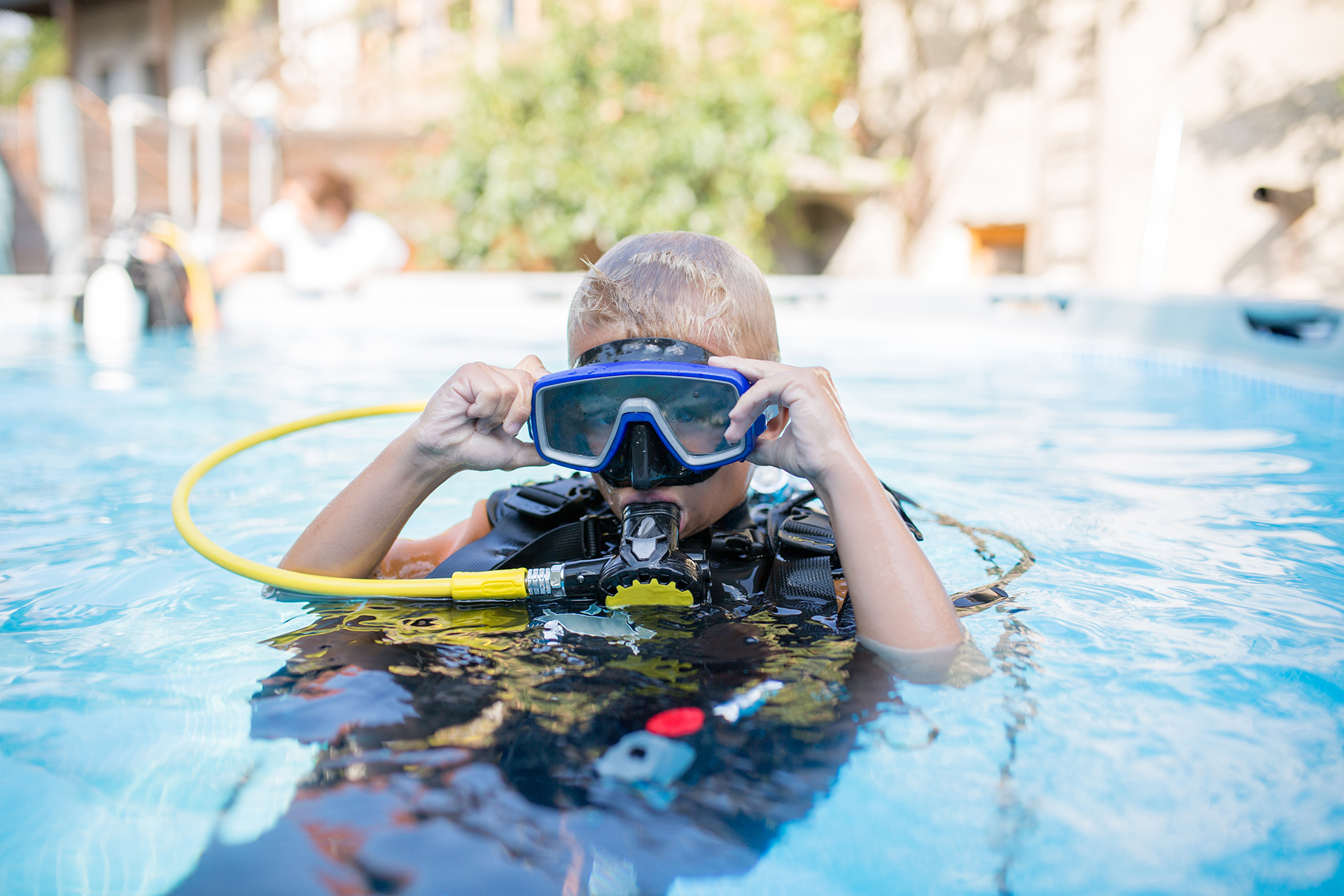 scuba diving with contacts child in a pool