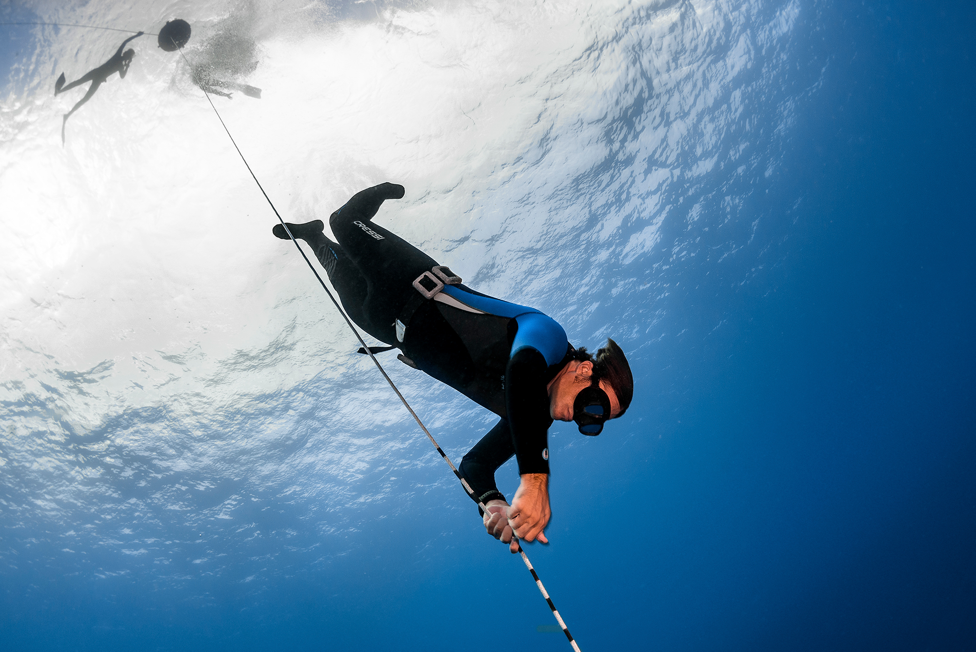 A PADI Freediver descending down a line during a free immersion dive, a popular activity at Dean's Blue Hole in The Bahamas