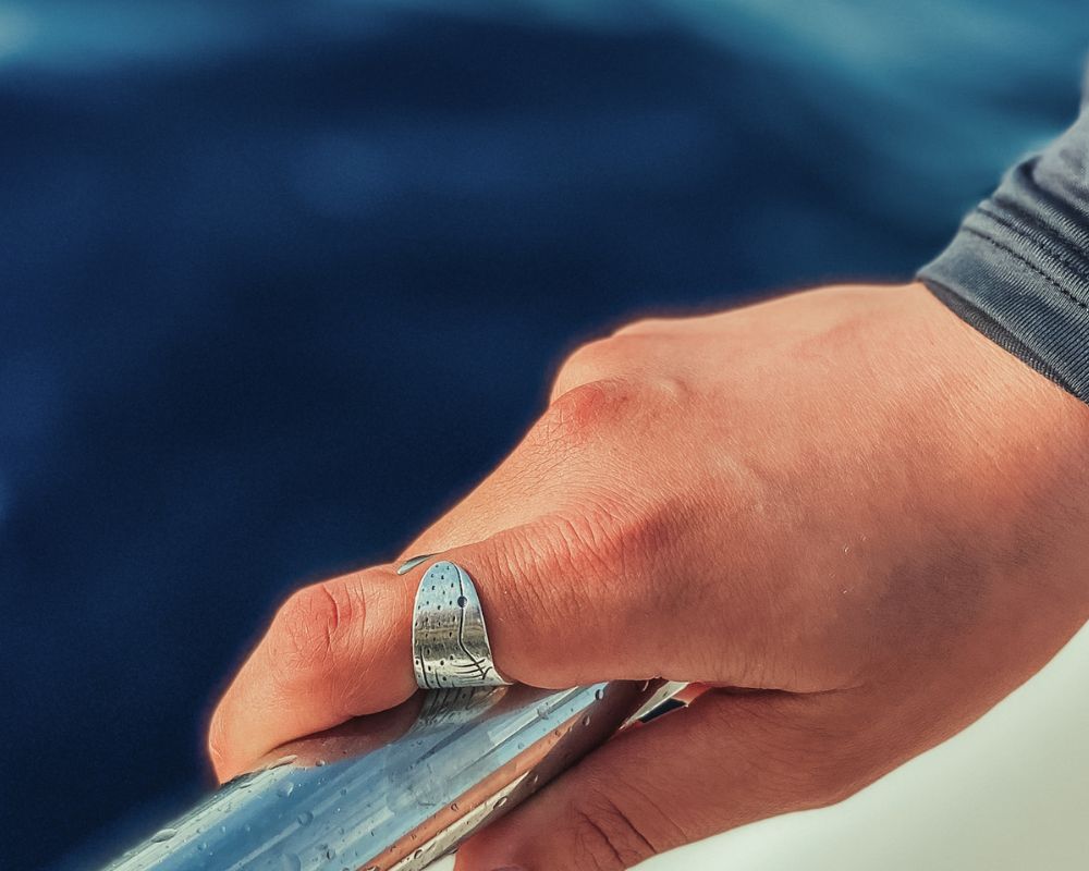 A whale shark ring shown on a model hand