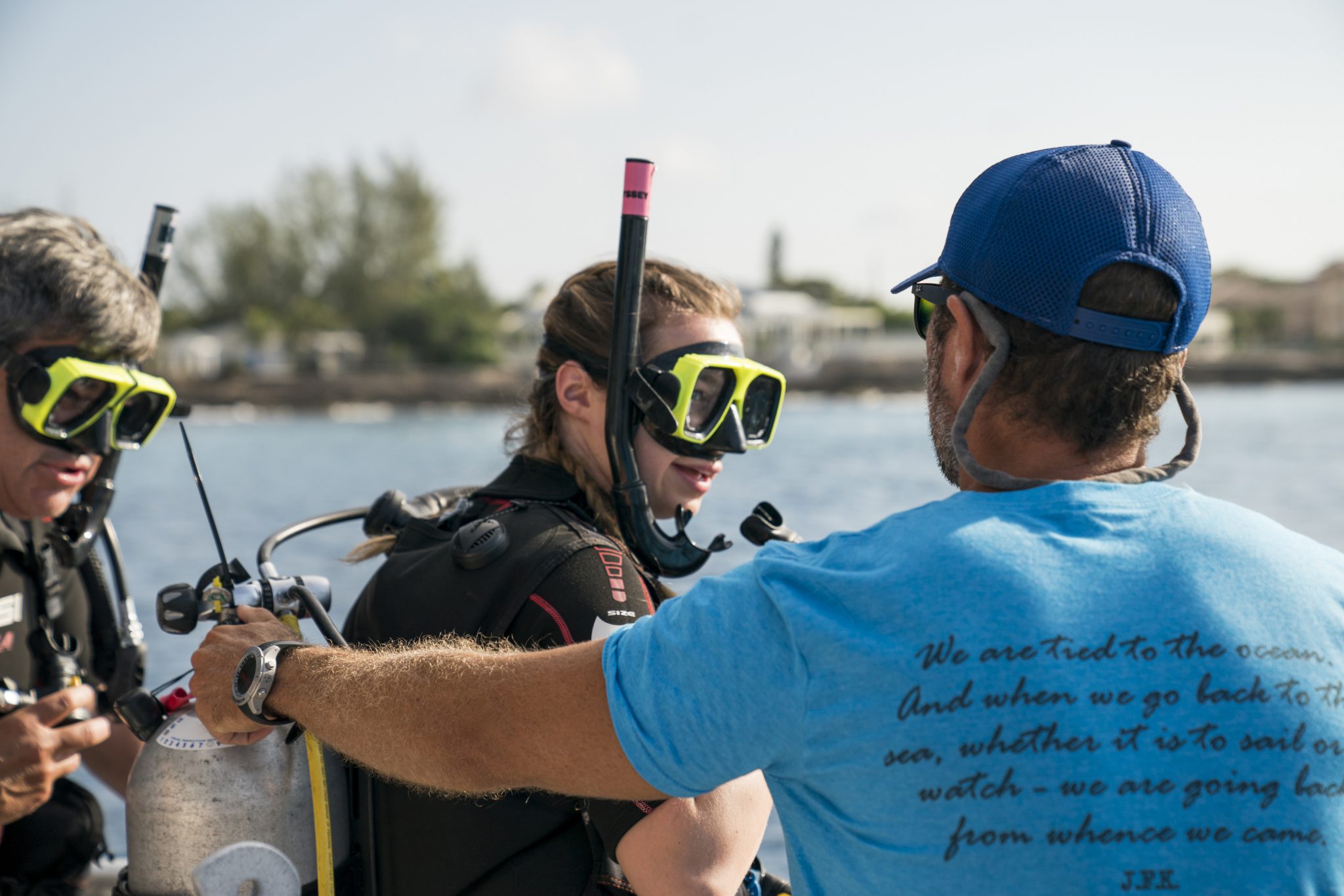 A PADI Pro reassuring a student during their scuba diving course, one of many roles in the life of a PADI Divemaster