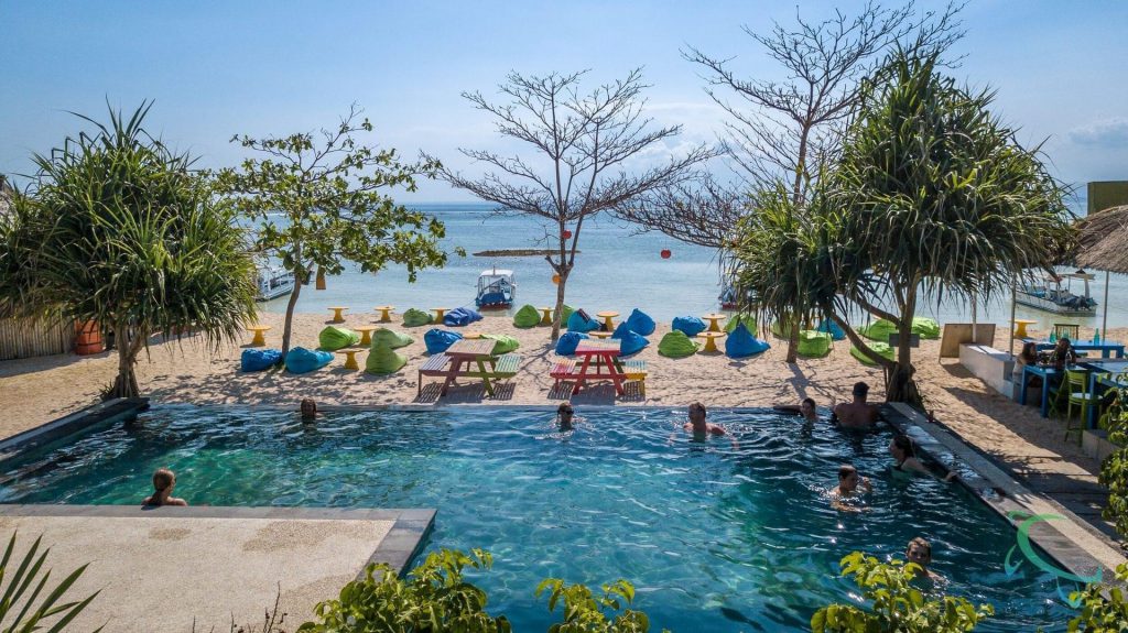 People swimming in the beach-side swimming pool at Blue Corner Dive Resort on Nusa Lembongan near Nusa Penida in Indonesia