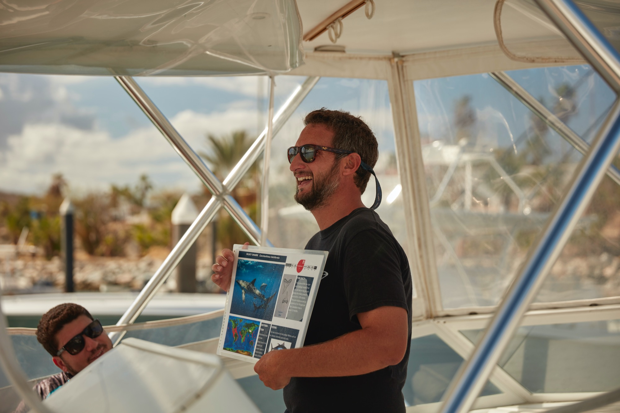 A PADI Pro delivers a dive briefing on a boat before a dive