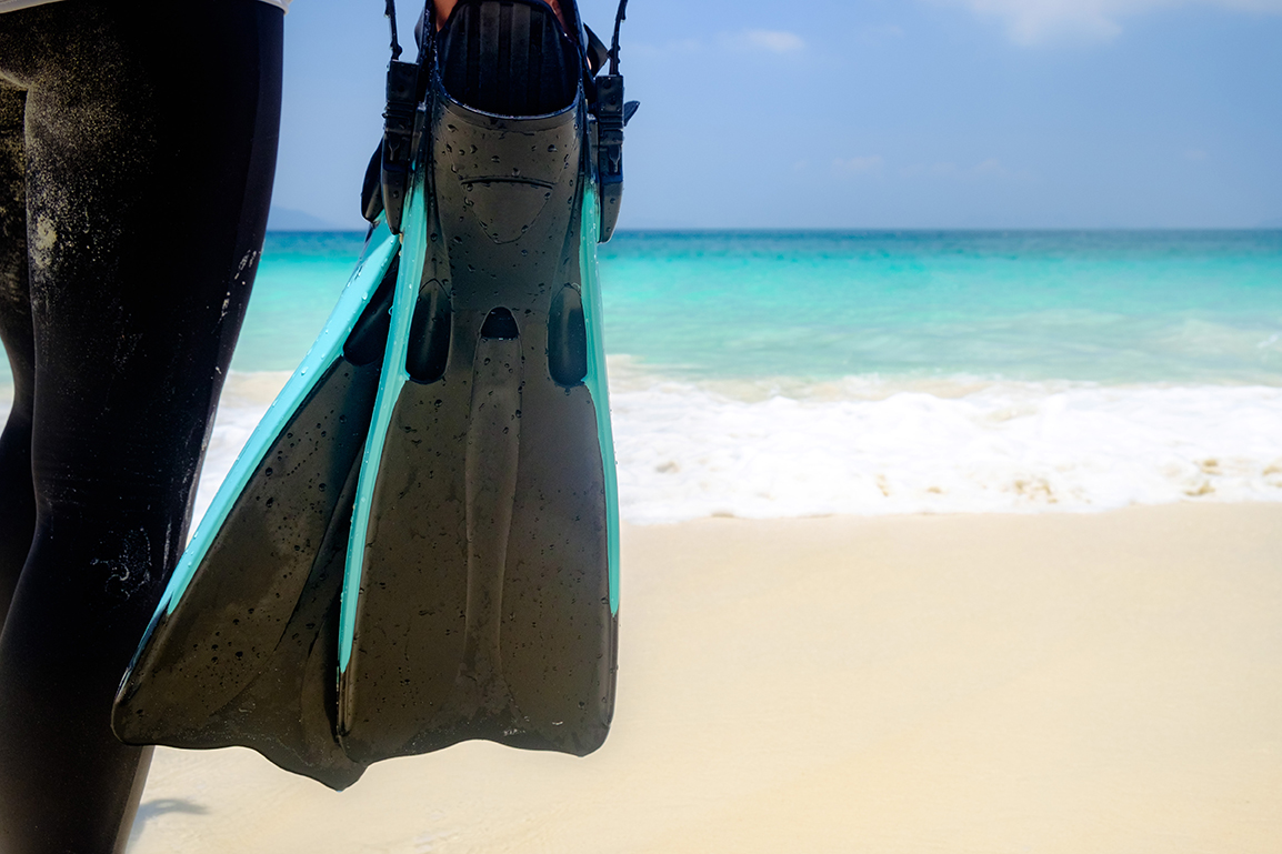 A close-up of a scuba diver's fins, which is the correct scuba terminology to use instead of saying flippers