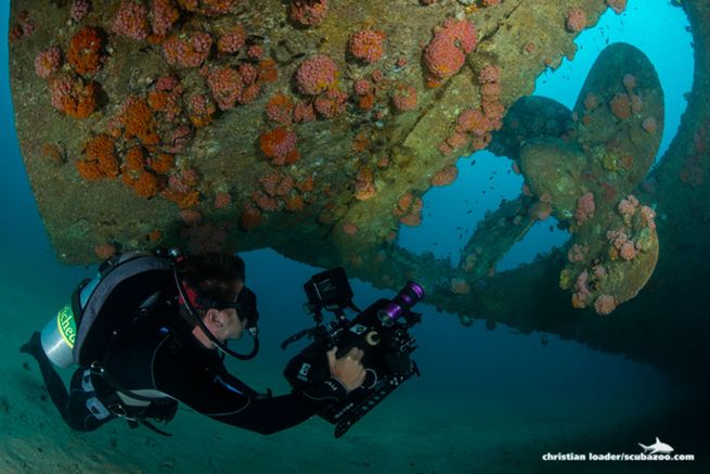 A scuba diver filming the propeller and rudder of the Pecheur Breton (Cargo Wreck), a staple of many Sri Lanka diving tours