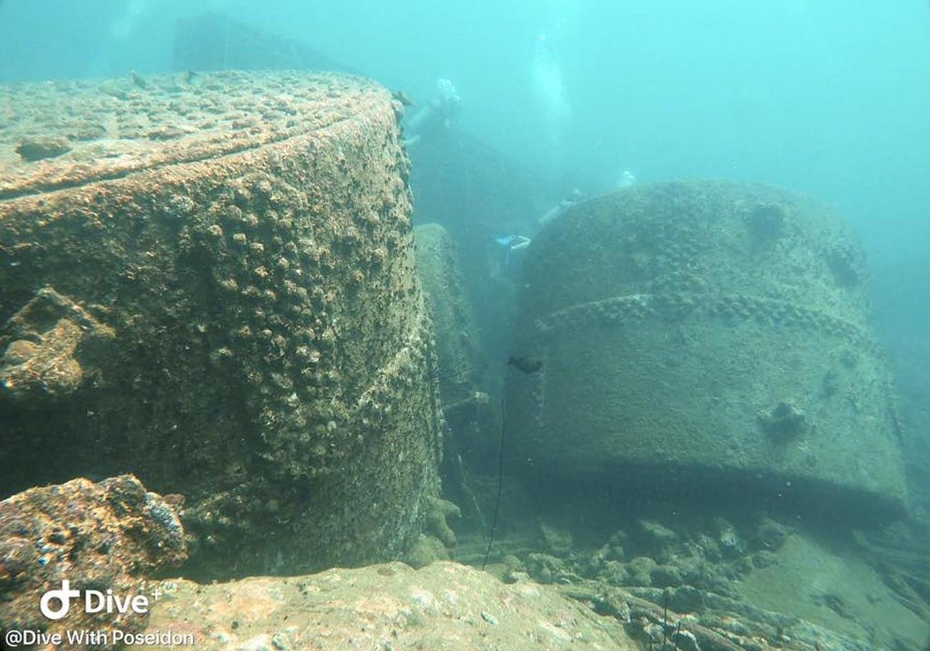 Scuba divers exploring the three giant boilers of the SS Conch shipwreck, which is one of the best Sri Lanka dive sites