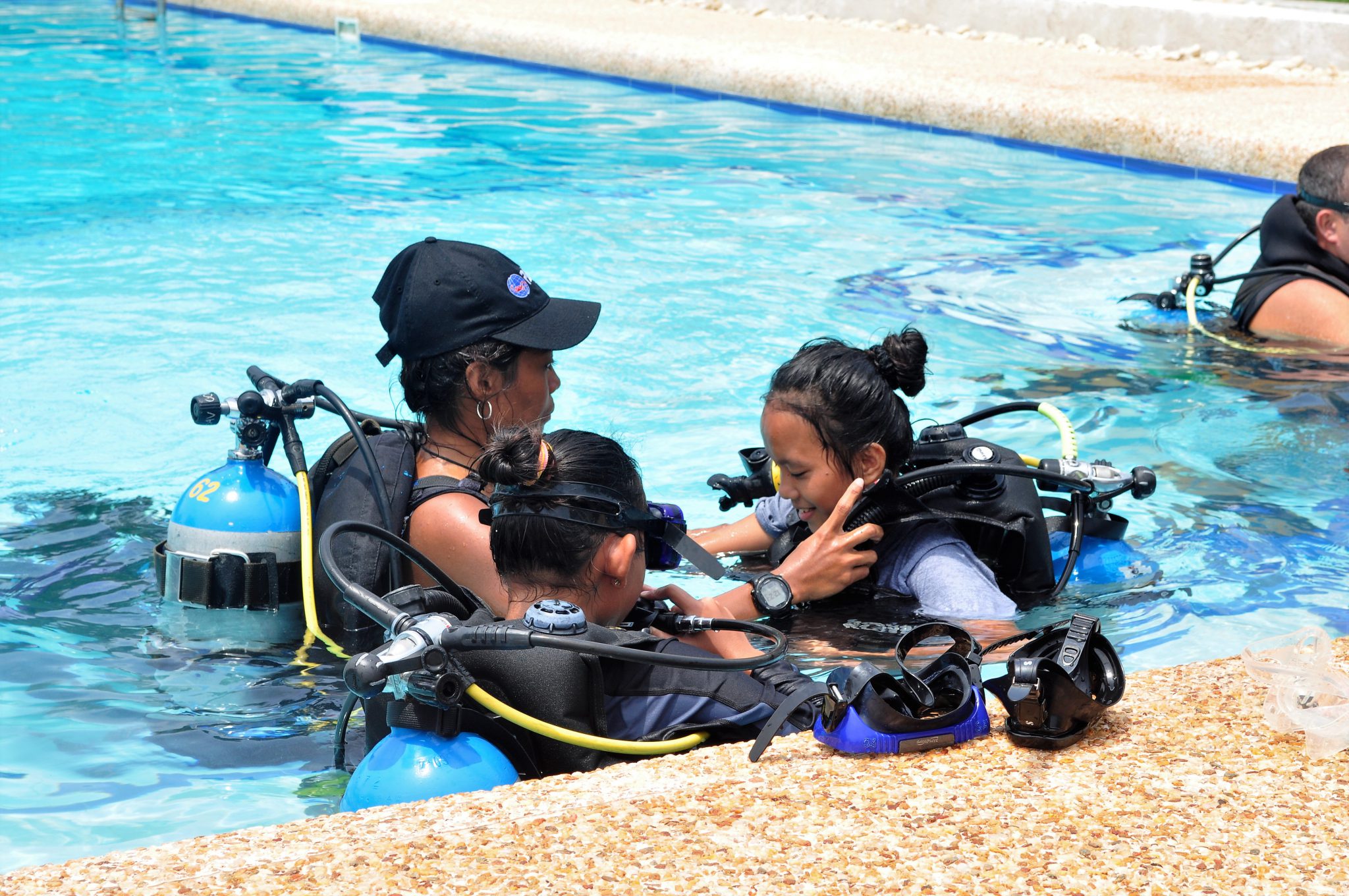 An instructor helps students with their gear