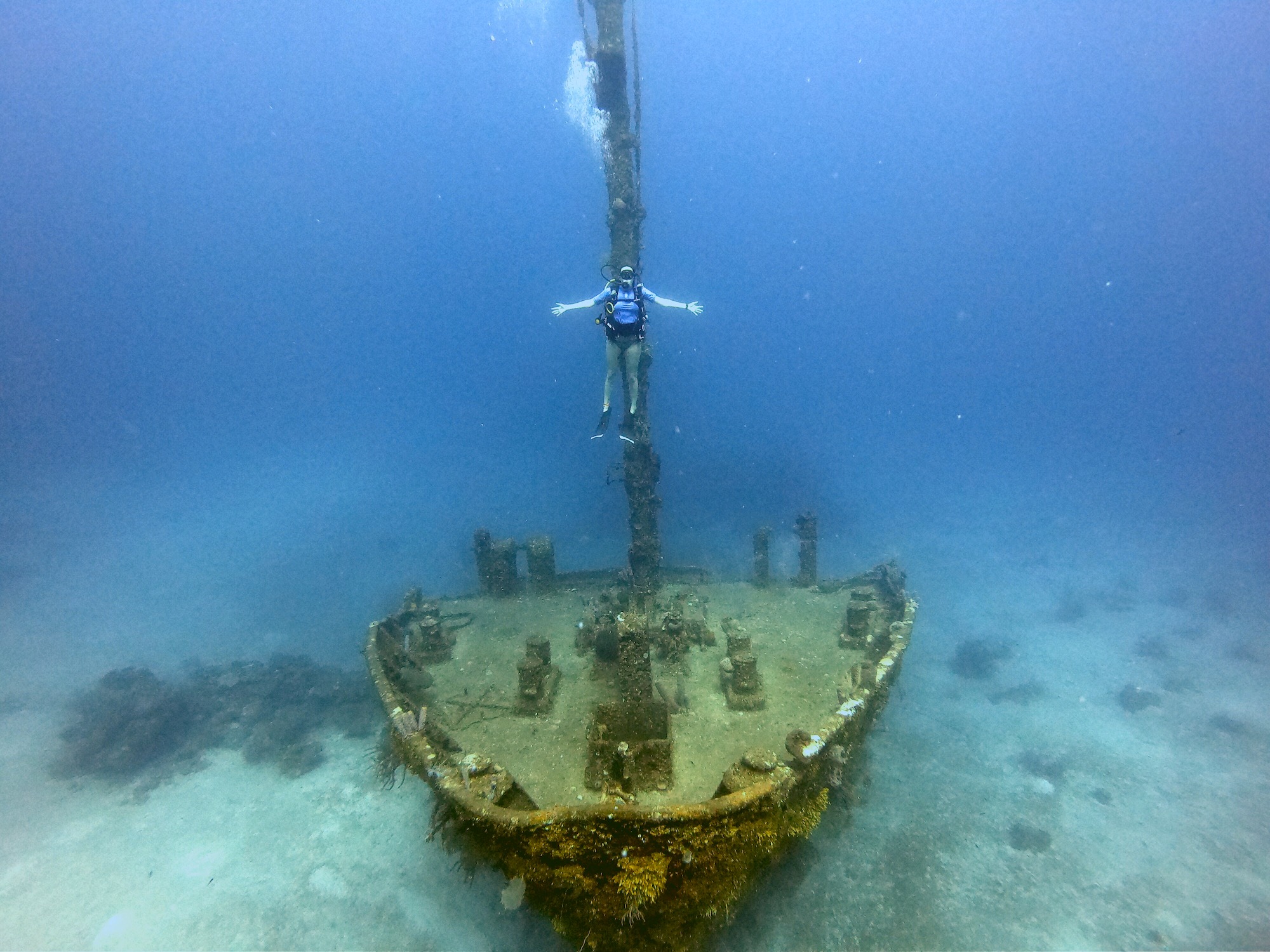 A scuba diver hovering above the El Aguila shipwreck in Roatan, Honduras, a destination that caters to every diver level