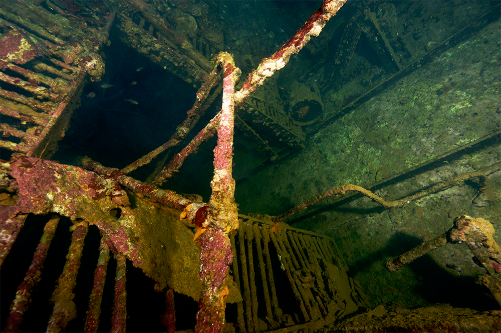 A scuba diver explores a WWII shipwreck in Coron Bay, Palawan, in the Philippines, which has some of the best diving in Asia