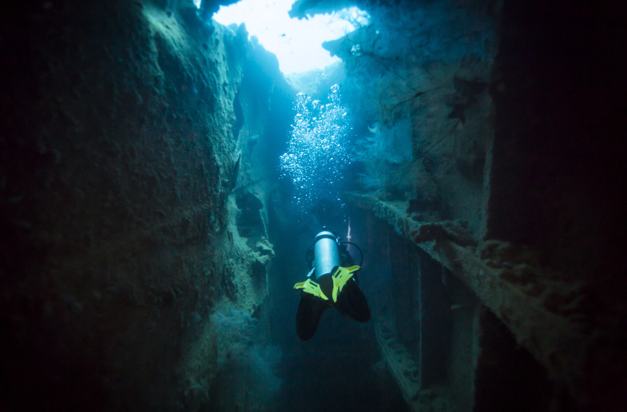 a scuba diver explores a wreck in Coron, Philippines
