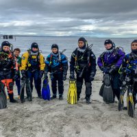teenage scuba divers in drysuits
