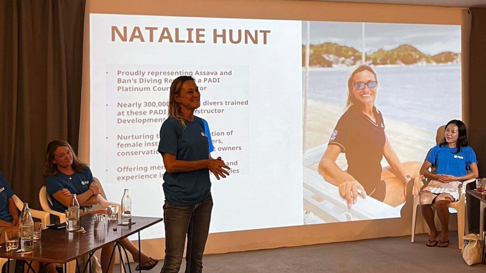 a woman gives a talk on women's dive day in thailand