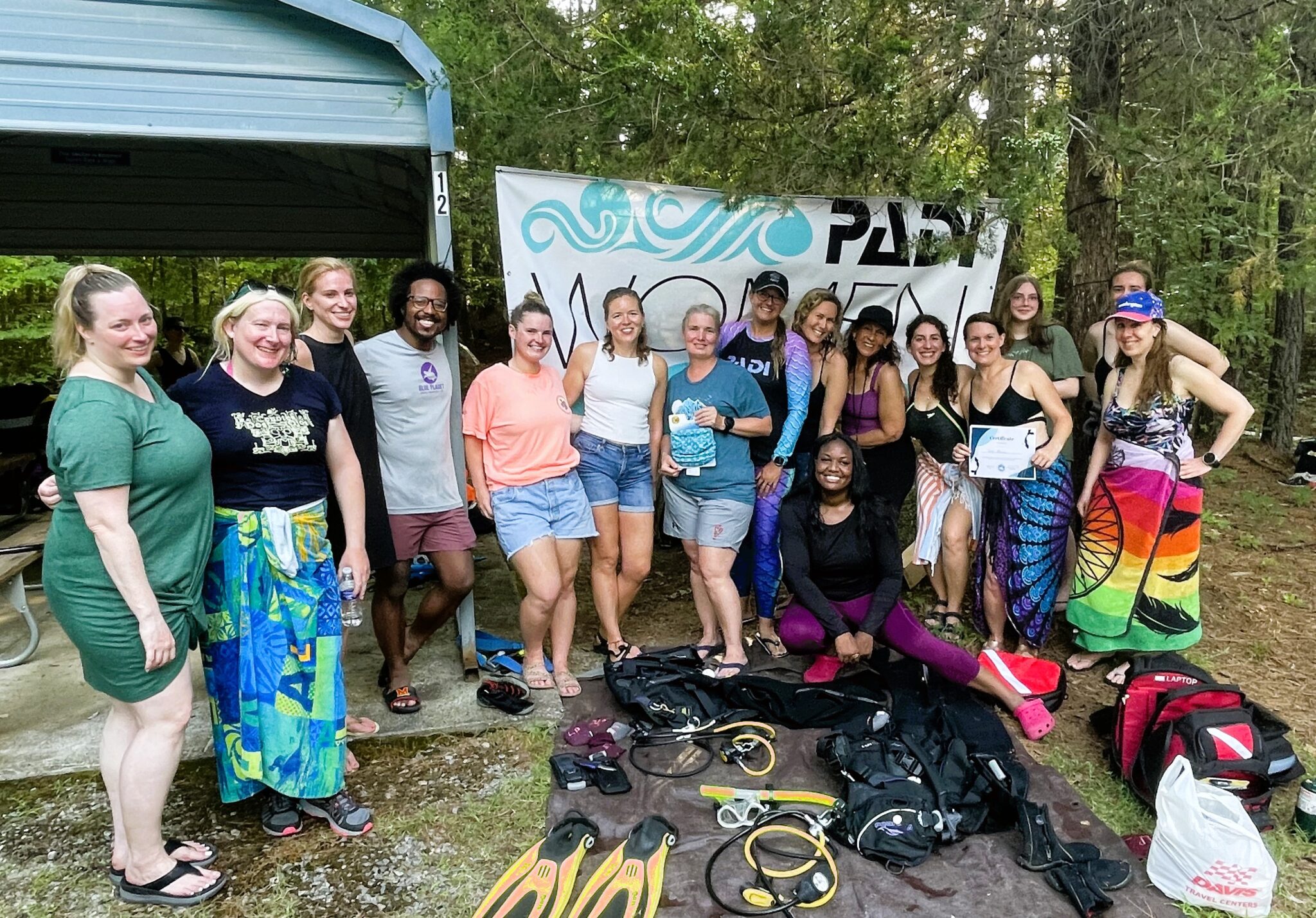 a group photo of divers after a dive on women's dive day