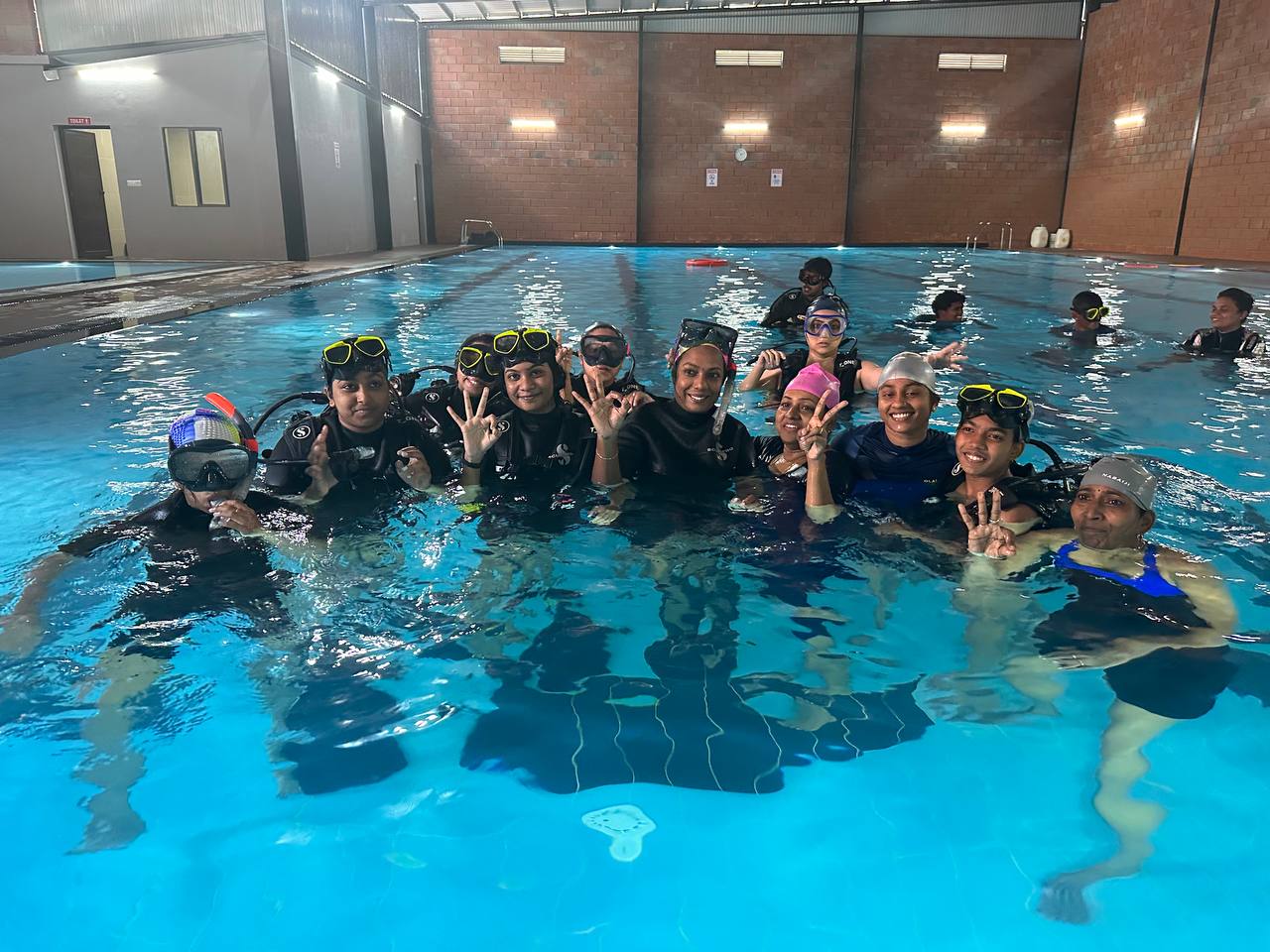 a group of women tries scuba diving in india for the first time during a women's dive day event