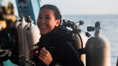 AmbassaDiver smiling on the boat in her dive gear.