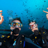 Two happy divers give the okay sign