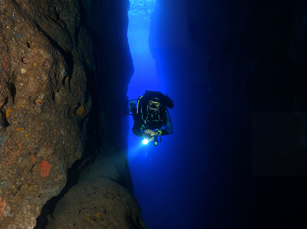 A scuba diver exploring the caves and tunnels at Gozo in Malta, which has some of the best shore diving in the world