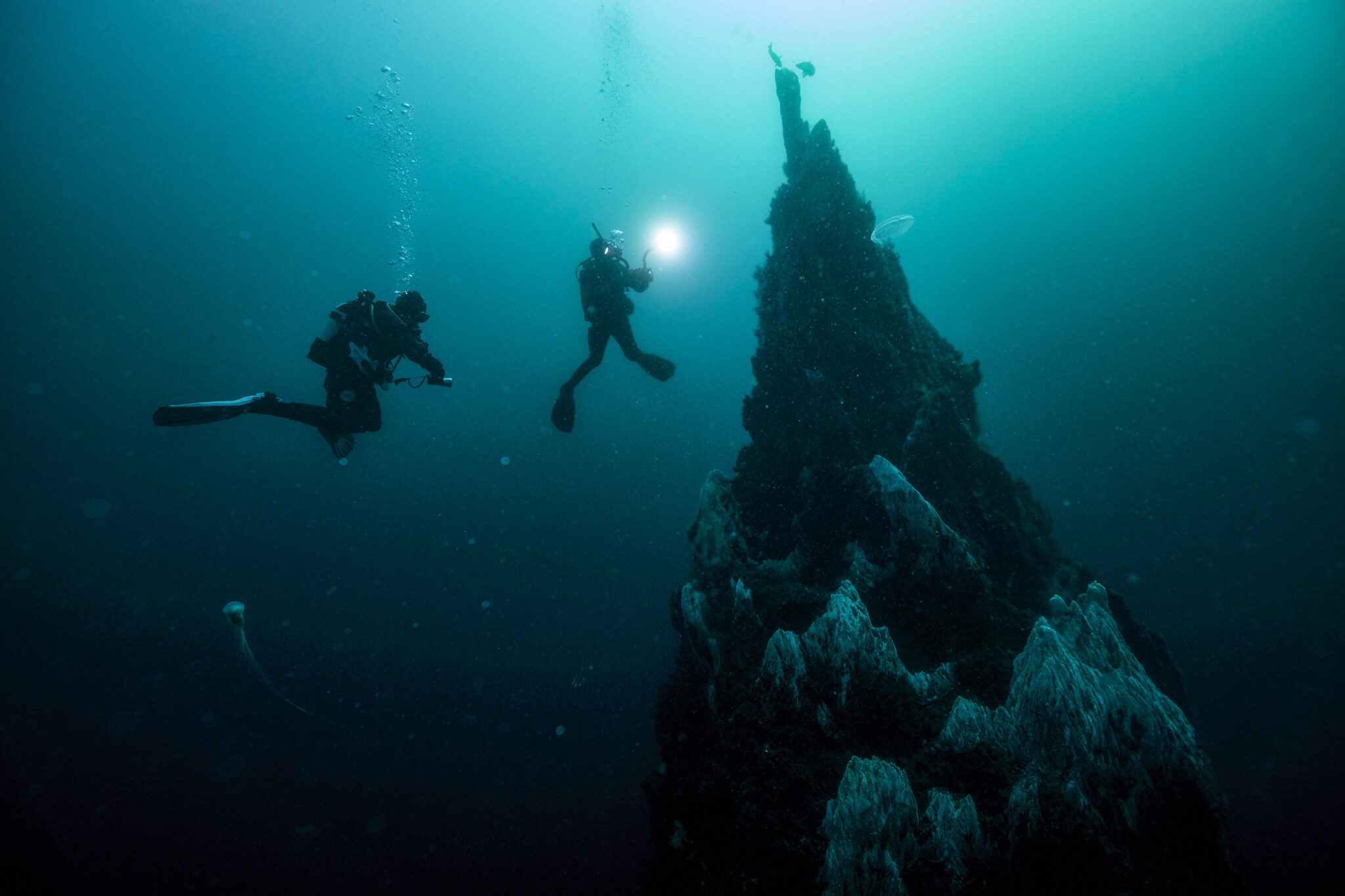 two divers near submerged pinnacle