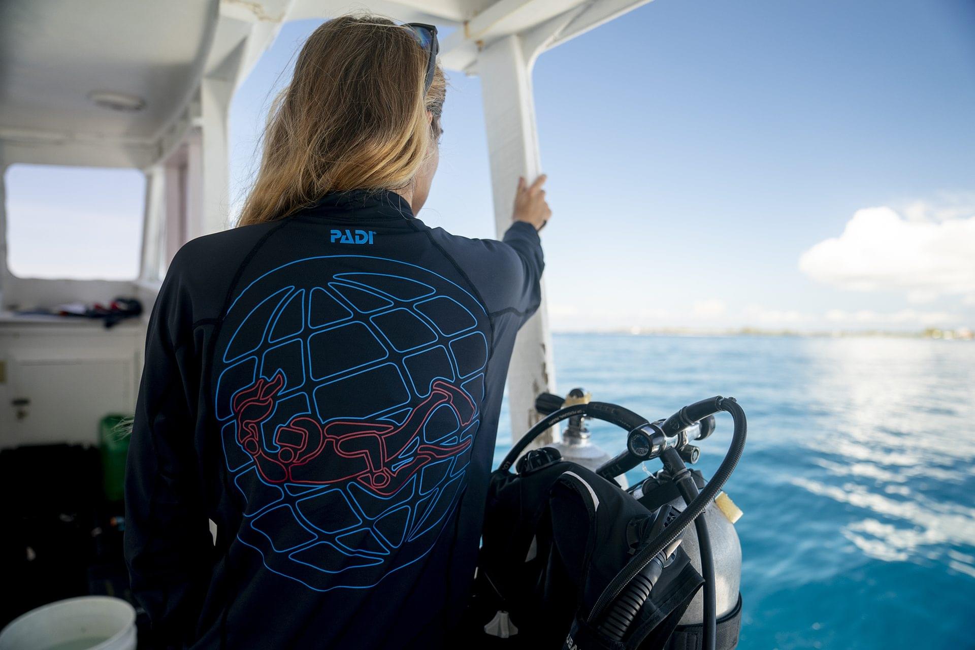 A PADI diver who has brought extra swimsuits after getting the best liveaboard advice about what to pack on a scuba vacation